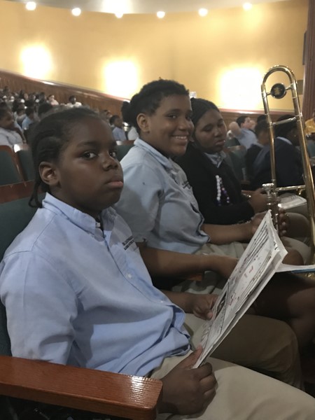 Performers wait in the audience to be called to perform at the day assembly concert.